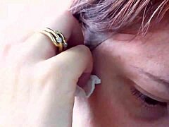 Nicoletta tries on earrings and gets fingered in this hot MILF video