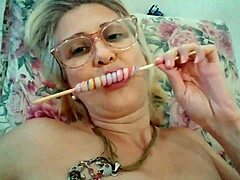 Mature pornstar Stella Still enjoys licking a lollipop in HD video