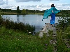 Žena v bikíne tancuje na jazere